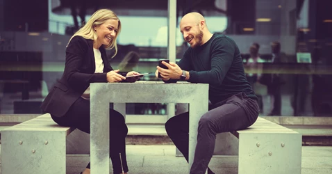 man-and-women-working-toghether-on-devices man-and-women-working-toghether-on-devices