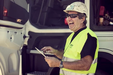 working-man-with-tablet-outside-his-truck working-man-with-tablet-outside-his-truck